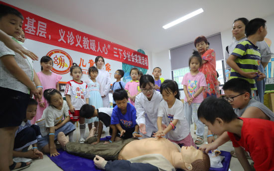 7月3日，湖南省衡阳市珠晖区酃湖乡，太阳成集团tyc33455cc护理公司的志愿者给小朋友讲解安全急救知识。曹正平 摄